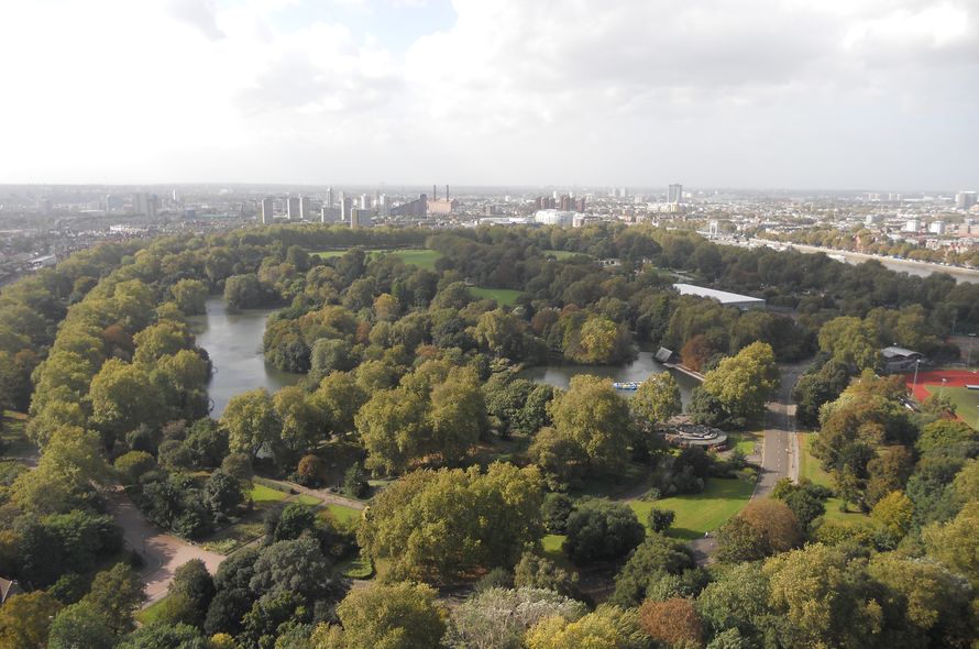 A landscape view of Battersea park with Battersea power station in the distance